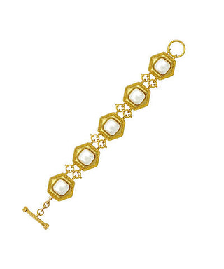 Gold keychain with a pointed end on a white background