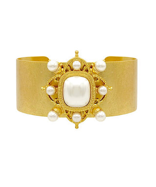 Gold bracelet with pearl embellishments on a white background