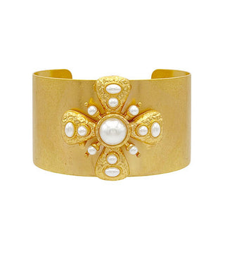 Gold cuff bracelet with pearl-like embellishments on a white background