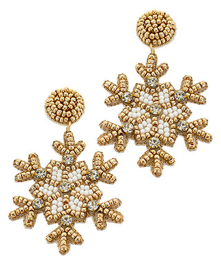 Gold and white beaded snowflake earrings on a white background