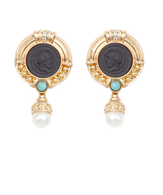 Gold earrings with black stones, turquoise beads, and pearl drops on a white background