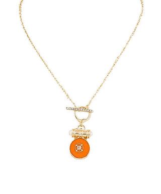 Gold necklace with a fire engine pendant on a white background