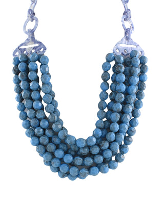 A multi-strand beaded necklace featuring textured blue faceted beads, suspended from silver-toned metal chains with decorative links, shown against a plain white background.