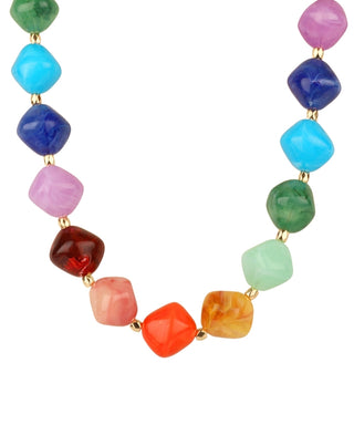A multicolor beaded necklace with faceted, rounded square beads in various colors including pink, blue, green, orange, and red, separated by small gold spacers, shown on a plain white background.