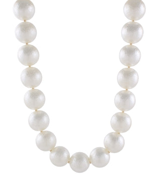 A strand of large, textured white faux-pearl beads arranged in a U-shape against a solid white background.