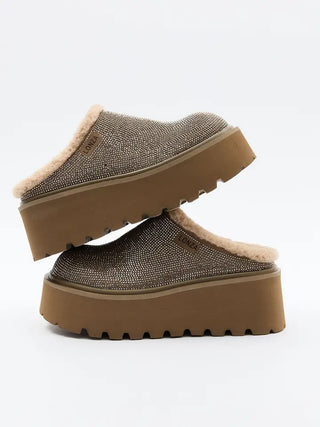 Brown slip-on shoes with a thick sole on a white background