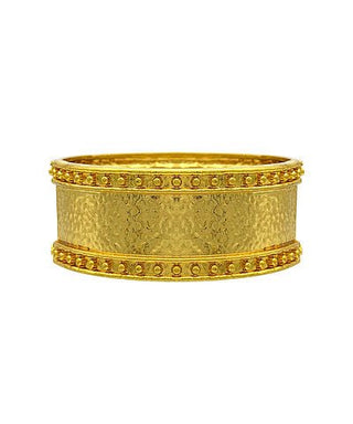 Gold bracelet with intricate design on a white background