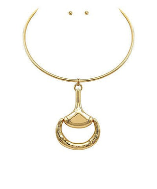 Gold necklace with a unique pendant on a white background