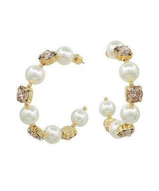 Pair of pearl and gold hoop earrings on a white background